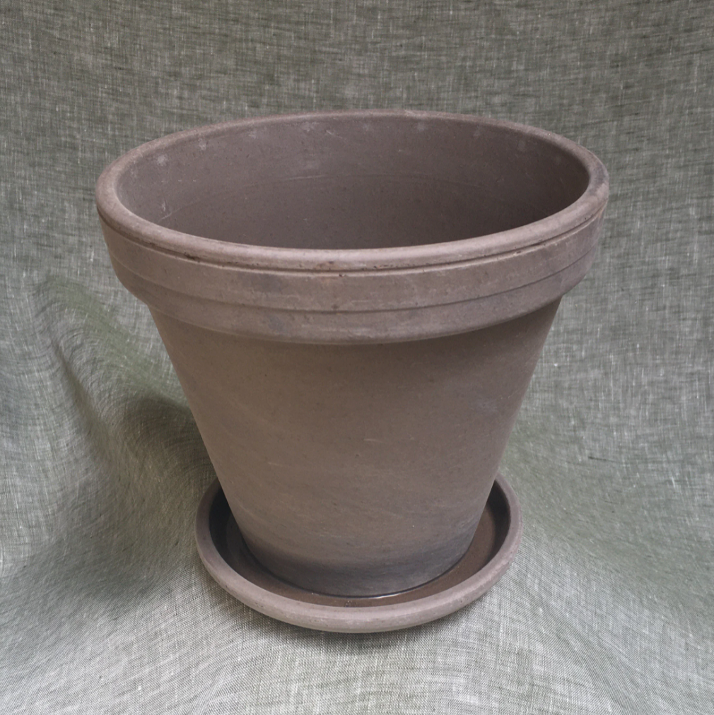Large brown clay pot with tray.